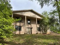 Suburban two-story home featuring a brick facade, large columns, and a well-maintained front lawn at 2831 Bettis Ct, Marietta, GA 30066