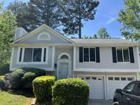 Charming two-story home with landscaped front yard and attached two-car garage at 2317 Wilkins Ct, Decatur, GA 30035