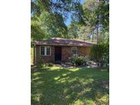 Charming brick home with inviting curb appeal and mature landscaping at 309 E Rhinehill E Rd, Atlanta, GA 30315