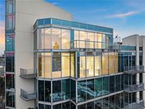 Modern condo exterior featuring floor to ceiling windows and balconies with views of the city skyline at 860 Peachtree Ne St # 2801, Atlanta, GA 30308
