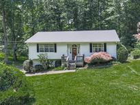 Charming single-story home featuring a lush lawn and welcoming front porch entrance at 301 Jetta Ln, Canton, GA 30115
