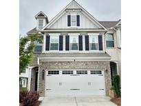 Charming two-story home featuring a gray brick facade, white siding, and a spacious two-car garage at 6128 Lanier Harbor Lndg, Buford, GA 30518