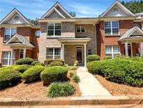 Charming brick townhome with manicured landscaping and inviting entryway at 2031 Austin Park Cir, Decatur, GA 30032