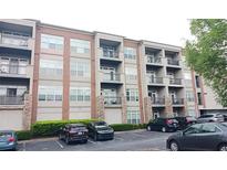 A modern building with many apartments, balconies, parking spaces, trees, and various cars at 840 United Se Ave # 408, Atlanta, GA 30312