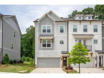 Charming townhome featuring neutral paint, attached garage, and manicured lawn at 3518 Mount Blue Ave, Tucker, GA 30084