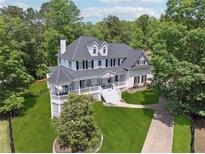 Stunning two-story home with a white exterior, black shutters, and a charming front porch at 471 Henderson Lake Dr, Canton, GA 30115