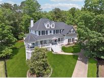 Stunning two-story home with a white exterior, black shutters, and a welcoming front porch at 471 Henderson Lake Dr, Canton, GA 30115