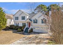Charming two-story home featuring a well-maintained yard and a two-car garage, perfect for suburban living at 239 Taylors Farm Drive Dr, Canton, GA 30115