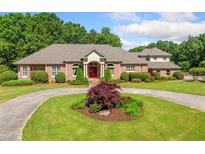 Stunning brick home features circular driveway and meticulously manicured landscaping at 226 Euharlee Five Forks Rd, Kingston, GA 30145