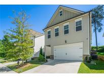 Charming two-story home with a two-car garage and manicured front lawn on a clear day at 4406 Richmond Ct, Stone Mountain, GA 30083