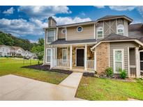 Charming two-story home with a black front door, stone accents, and a well-manicured lawn at 924 Park Gate Pl, Stone Mountain, GA 30083