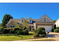 Charming home featuring a stone-accented facade, manicured landscaping, and a welcoming two-car garage at 2642 Colleen Ln, Dacula, GA 30019