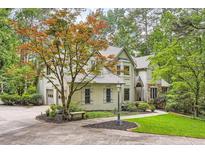 Charming traditional-style home with manicured landscaping and mature trees in a serene, wooded setting at 5161 Hermitage Dr, Powder Springs, GA 30127