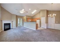 Spacious living room with fireplace, ceiling fan, and open access to kitchen with breakfast bar at 580 Camry Cir, Dallas, GA 30157