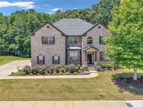 Charming two-story brick home with lush lawn and manicured landscaping at 271 Learwood Ln, Atlanta, GA 30349