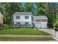 Charming two-story home featuring a covered front porch, red shutters, and a well-manicured lawn at 3856 Nowlin Nw Rd, Kennesaw, GA 30144