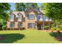 Stunning two-story brick home featuring a well-manicured lawn and a welcoming front porch at 2470 Anderson Estates Ct, Marietta, GA 30064