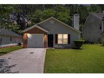 Charming single-story home with well-maintained lawn and attached one-car garage at 4378 Chestnut Oaks Trce, Lithonia, GA 30038