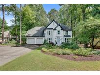 Charming two-story home with three-car garage and beautifully landscaped front yard at 3250 Cobbs Farm Nw Trl, Marietta, GA 30064