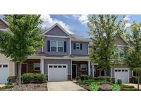 Charming townhome featuring stone accents, a one car garage, and well maintained landscaping at 532 Oakside Pl, Acworth, GA 30102