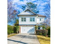 Beautiful two-story home with white siding, stone accents, well-manicured landscaping, and a two-car garage at 2603 Apple Valley Ne Rd, Brookhaven, GA 30319