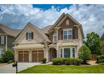 Charming two-story home featuring a well-manicured lawn and a two-car garage at 4652 Prater Se Way, Smyrna, GA 30080