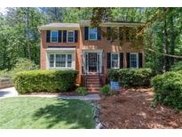 Charming two-story brick home with a well-manicured lawn and mature landscaping in a desirable neighborhood at 2122 Rockland Ct, Marietta, GA 30062