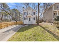 Charming two-story home with white siding, black shutters, and inviting front yard at 2453 Paul Nw Ave, Atlanta, GA 30318