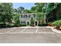Charming townhome featuring reserved parking, a classic facade, and inviting curb appeal with mature landscaping at 1750 Clairmont Rd # 35, Decatur, GA 30033