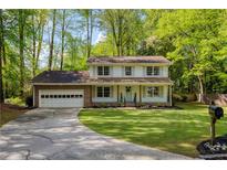Charming two-story home with a brick garage, well-manicured lawn, and beautiful landscaping at 3719 Northbrook Ct, Atlanta, GA 30340
