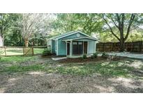 Charming home with a landscaped front yard, fenced area, and mature trees at 4443 Toonigh Nw Rd, Acworth, GA 30101