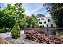 Modern two-story home featuring a horizontal wood fence and lush landscaping at 1099 Vista Ne Trl, Atlanta, GA 30324
