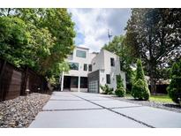 Modern home featuring a striking geometric driveway and lush surrounding greenery at 1099 Vista Ne Trl, Atlanta, GA 30324