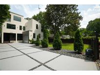 Striking modern home with a unique driveway and meticulously manicured landscaping at 1099 Vista Ne Trl, Atlanta, GA 30324