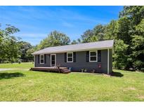 Charming single-story home with a well-maintained lawn and a cozy front porch at 130 Driver St, Temple, GA 30179