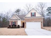 Charming single-story home with a brick and siding exterior and well-manicured landscaping at 1431 Beckett Dr, Hampton, GA 30228