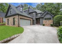 Stunning home features a stone facade, a gray color scheme and attached two-car garage at 2255 Lenox Ridge Ne Ct, Atlanta, GA 30319