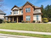 Charming two-story home with a welcoming front porch and well-manicured lawn at 533 Mount Gerizim Se Rd, Mableton, GA 30126