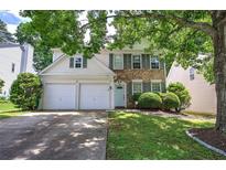 Charming two-story home with a manicured lawn, brick accents, gray shutters and a two-car garage at 2908 Cottesford Se Way, Smyrna, GA 30080