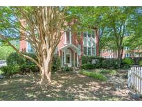 Charming brick apartment building with a well-manicured lawn and mature trees at , Atlanta, GA 30306