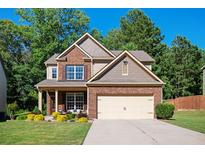 Charming two-story home with brick and siding, a well-manicured lawn, and an attached two-car garage at 3537 Edenridge Ct, Buford, GA 30519