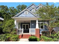 Charming two-story home with a covered front porch and beautifully landscaped front yard at 132 Olympic Pl, Decatur, GA 30030