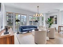 Bright living room with modern furnishings, large windows, and hardwood floors at 775 Juniper Ne St # 327, Atlanta, GA 30308