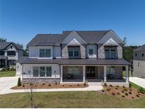Stunning two-story home featuring stone accents, black trim, and a welcoming front porch at 2996 Treeside Ter, Marietta, GA 30066
