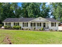 Charming one-story home boasts a well-maintained lawn and inviting front porch at 3210 Roseheath Ln, Lithonia, GA 30038