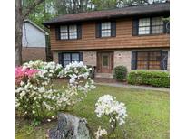 Charming two-story home with well-maintained lawn, blossoming azaleas and a welcoming front entrance at 3352 Northbrook Dr, Atlanta, GA 30340