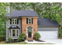 Charming two-story home features a brick archway and a welcoming front door with lovely landscaping at 4806 Deer Chase, Powder Springs, GA 30127