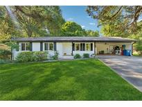 Charming one-story home with manicured lawn and convenient carport at 512 Plantation Blvd, Lawrenceville, GA 30046