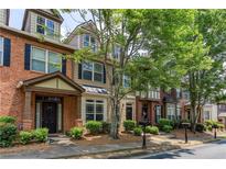 Charming townhomes featuring varied facades and manicured landscaping create inviting curb appeal at 529 Ridge View Crossing Xing, Woodstock, GA 30188