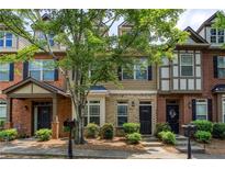 Charming townhomes with brick and siding exteriors, landscaped front yards, and inviting entrances at 529 Ridge View Crossing Xing, Woodstock, GA 30188